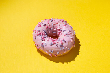 donut with sweet powder on a yellow background