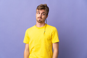Young handsome blonde man isolated on purple background making doubts gesture looking side