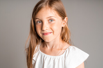 stylish little girl portrait in the studio grey background