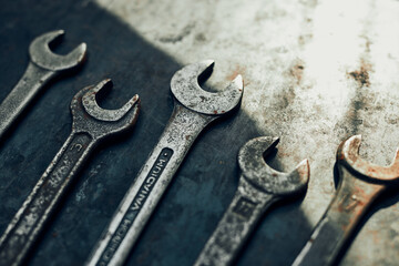 Spanners on steel surface. Old rusty wrenches for maintenance. Mechanic hardware tools to fix. Technical tools background