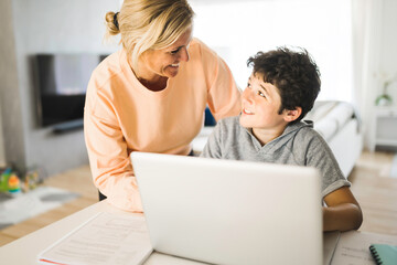 Mom helping kid with homework at home