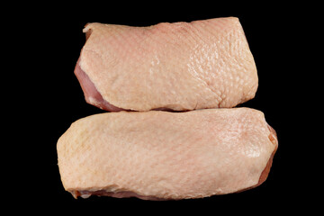 Two fatty duck fillets shot from above on black