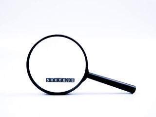 An image of magnifying glass and cube alphabets 