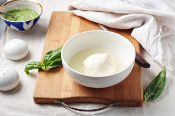 Mozzarella cheese ball in a bowl.