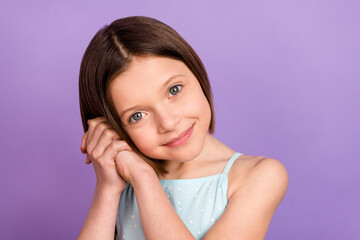 Photo of adorable happy small little girl hold hands face good mood grateful isolated on violet...