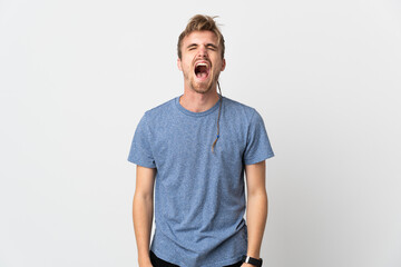 Young handsome man isolated on white background shouting to the front with mouth wide open