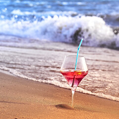 Wine glass with a cocktail by the sea.