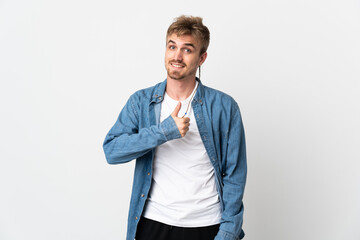 Young handsome man isolated on white background giving a thumbs up gesture