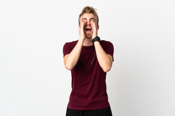 Young handsome man isolated on white background shouting and announcing something