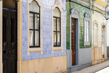 Fototapeta na wymiar Beautiful houses cover with traditional tiles called azulejo, Olhao, Portugal