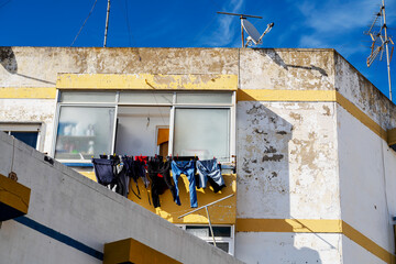 Weathered house with drying laundry in Olhao, Algarve, Portugal