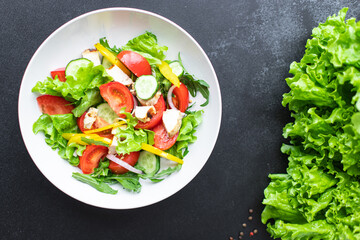 fresh chicken salad and vegetables tomato, cucumber, pepper organic wholesome dish on the table healthy food meal snack copy space food background rustic. top view keto or paleo diet veggie