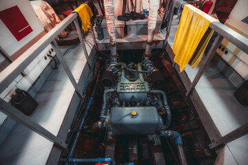 A wide-angle view of a huge powerful gasoline diesel engine of a yacht, or a boat, or a small ship,...