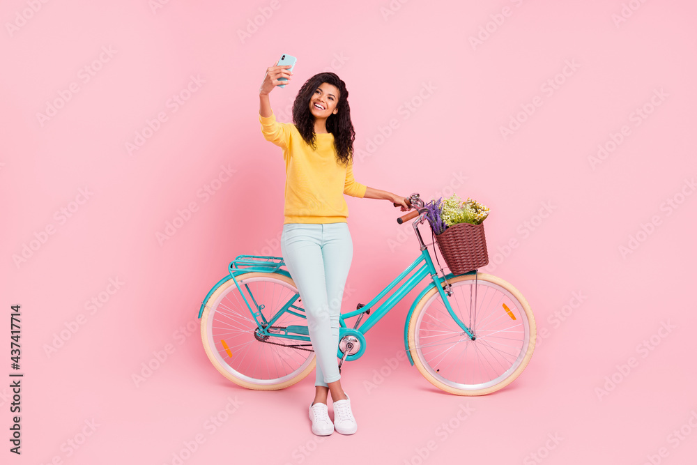 Poster Full length body size view of pretty trendy cheerful girl with bike taking selfie having fun isolated over pastel pink color background