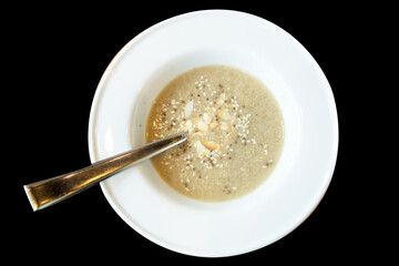 Top view of mixed mushroom soup on black isolated.