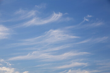 blue sky with white clouds of various shapes, sunny day, texture