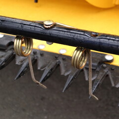 Metal spring on the header. Spring on the combine.