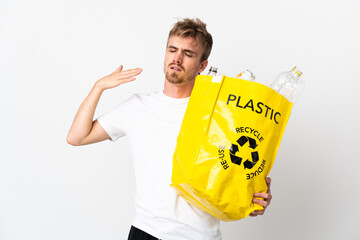 Young blonde man holding a recycling bag full of paper to recycle isolated on white background with...