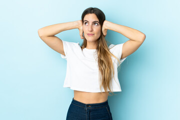 Young caucasian woman over isolated background frustrated and covering ears