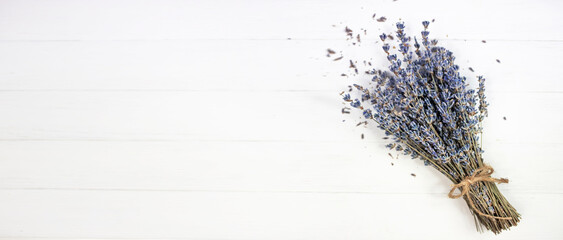 Bouquet of dried lavender on a white wooden background. Flat lay.