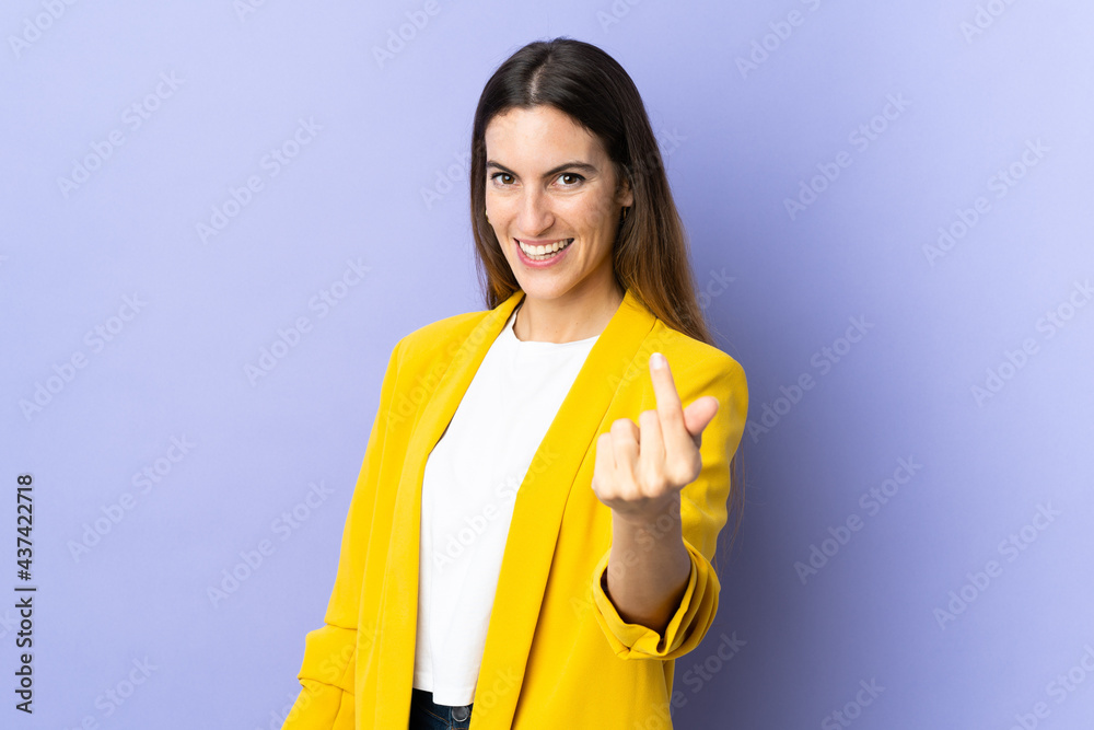 Wall mural young caucasian woman over isolated background making money gesture