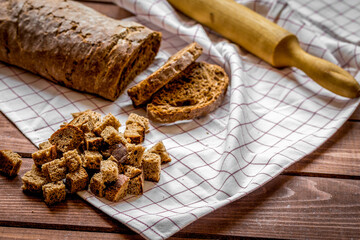 Dried crumbs with bread on kitchen table background