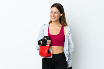 Young sport woman over isolated background with boxing gloves