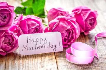 Spring design with peony flower and Mother's Day greeting card wooden background