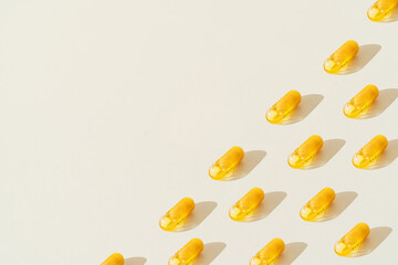 Yellow pills on white background. half of the picture is occupied by pills.