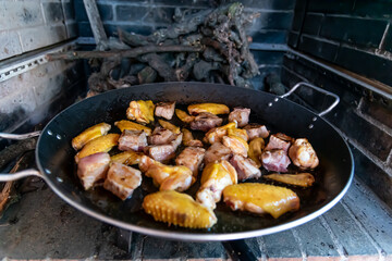 Preparation of typical Spanish food paella with chicken meat pork rice and vegetables