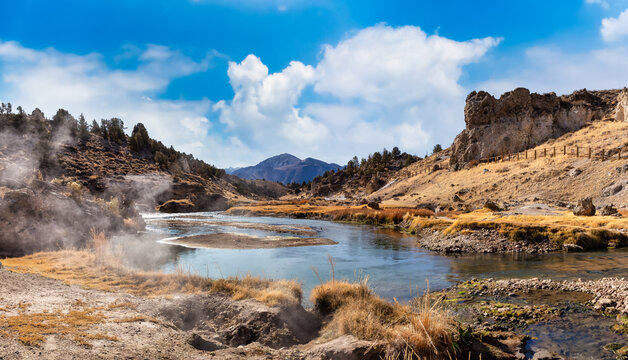 View of natural Hot Springs at Hot Creek Geological Site. Located near Mammoth Lakes, California, United States. Blue Sky Sunny Day Colorful Art Render