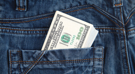 Dollar banknotes in jeans pocket.