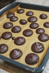 Process of making homemade chocolate cookies: hot biscuits taken out of the oven.