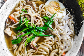 Ramen with seaweed noodles broth on pork meat.