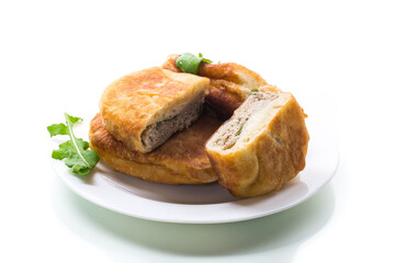 fried pies with meat in a plate on a white