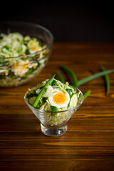 spring salad with early cabbage, cucumbers, eggs and green onions