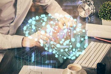 Double exposure of man's hand holding and using a digital device and brain hologram drawing. Data concept.