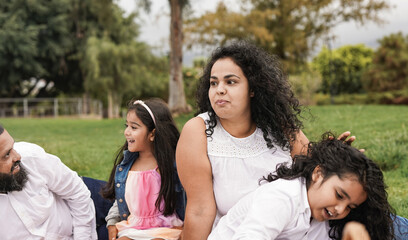 Indian family enjoy pic nic at city park - Family, parents and children love concept