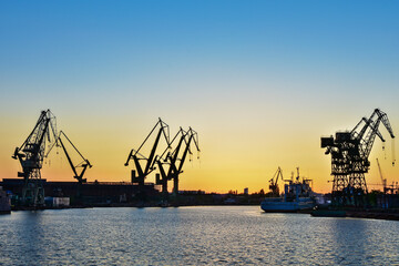 Fototapeta na wymiar Beautiful sunset and cranes in a shipyard in Gdansk, Poland