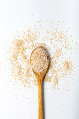 Wheat germ in wooden spoon on white background.