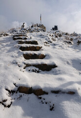 Stairs up to the Mirador la Gargallosa viewpoint, in Gisclareny, after a winter snowfall (Berguedà, Catalonia, Spain, Pyrenees)