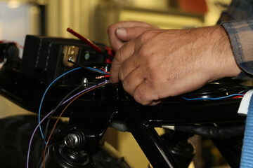 close up of a person working on a motorcycle