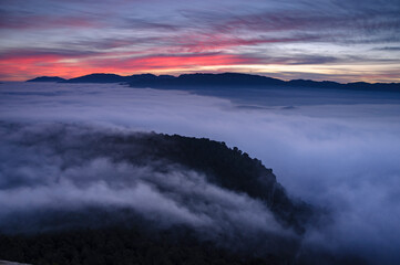 Sunrise with a sea of clouds over the Sau Reservoir seen from Roca del Migdia summit (Collsacabra, Catalonia, Spain)