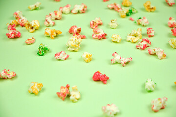 Colorful popcorn on a green background