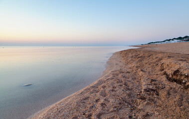  sunrise on the sea beach, with calm tranquil sea ang magnificient purple sky..