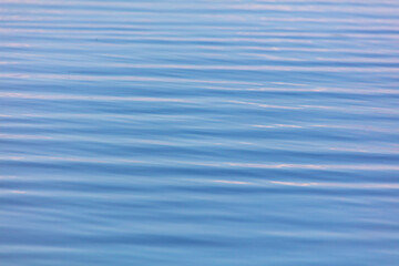 The smooth surface of the water in the lake as an abstract background.