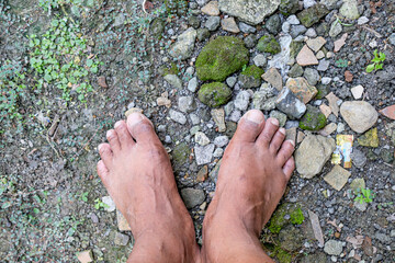 bare feet without shoes on the ground