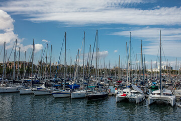 Fototapeta na wymiar Sailing boat parking on the shore of Barcelona, summer background
