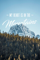 My heart is in the mountains text with trees and a mountain peak in the foreground