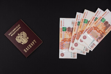 Russian passport and Russian currency on a black background